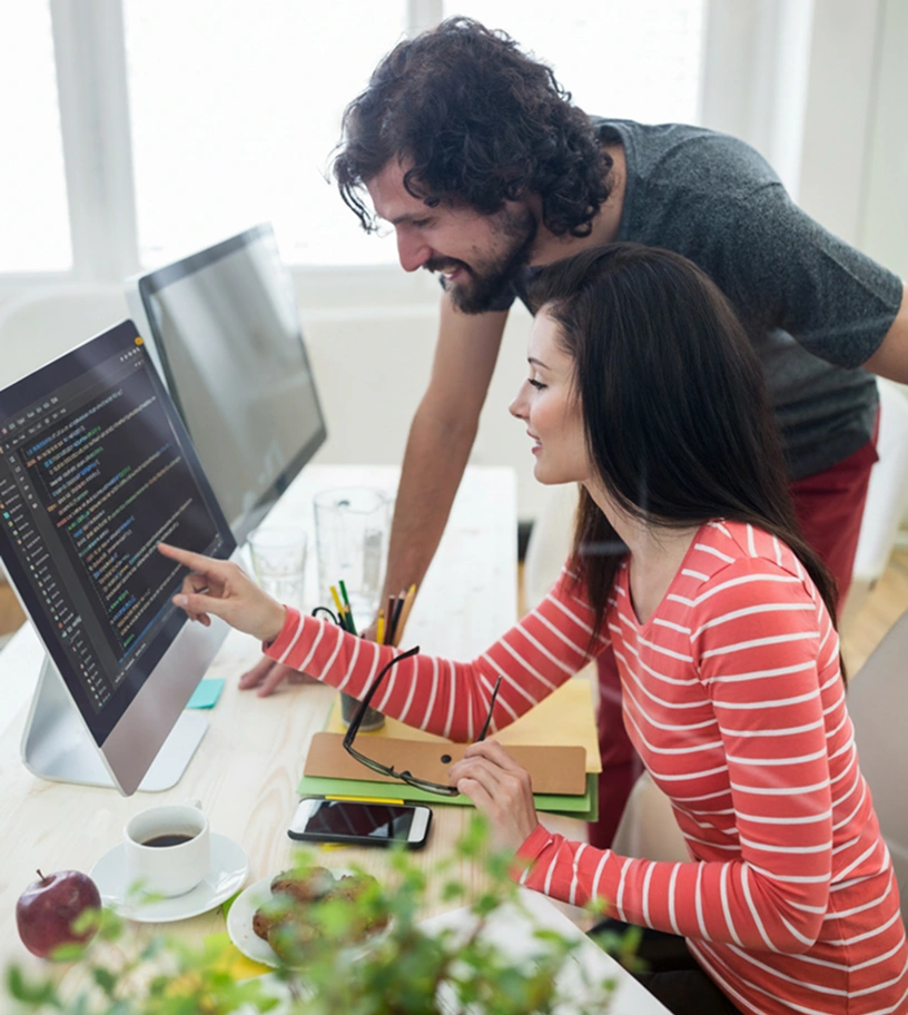 Website maintenance agency team reviewing and managing site performance on a desktop computer