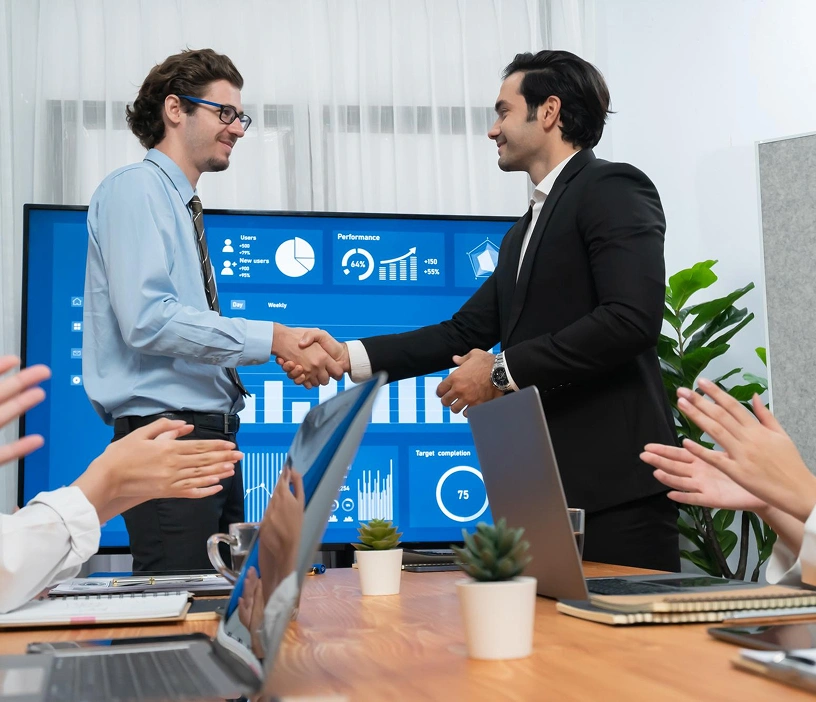 Business professionals closing a deal using CRM analytics dashboard