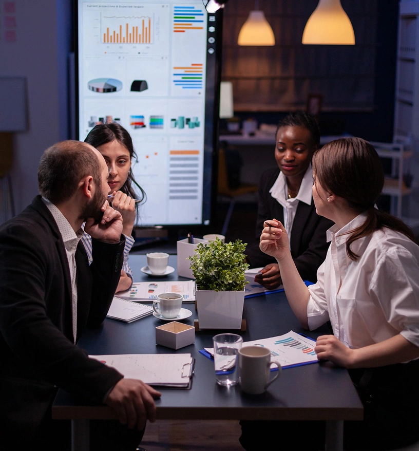 CRM agency team discussing dashboard analytics and business performance